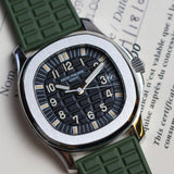 Watch with green strap on a document background