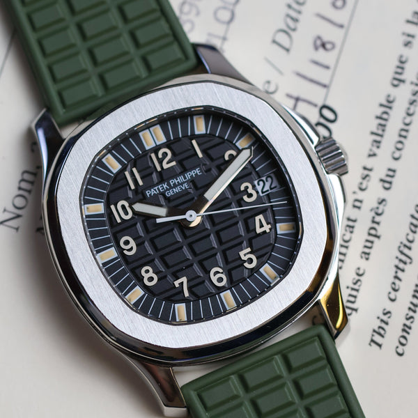 Watch with green strap on a document background